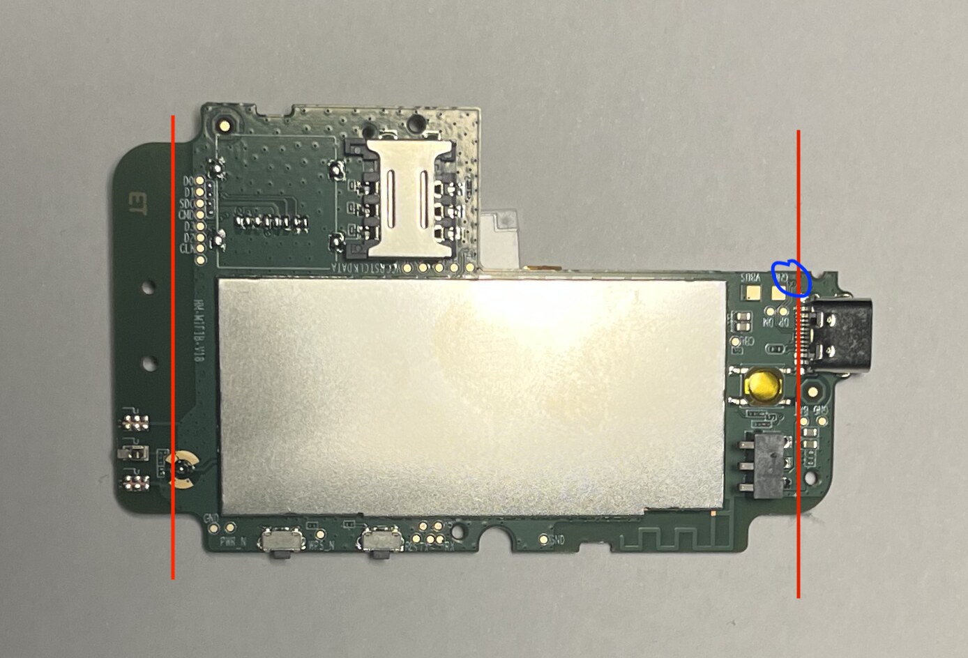 Bottom, red lines mark where I was planning to cut and the blue circle marks the via for USB data test pads